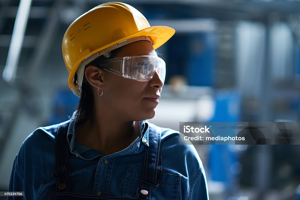 Best worker African woman finding strengths to finish work Hardhat Stock Photo