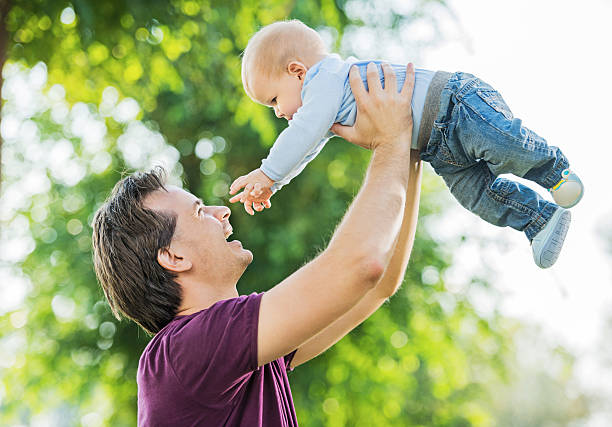 istock Baby boy and his father in nature. 475227771