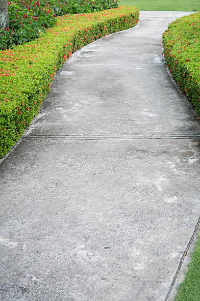 istock Abstract of concrete sidewalk and grass 475228676