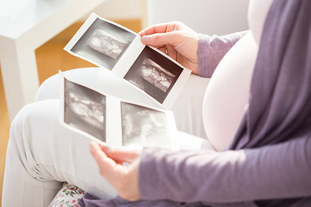 istock Future mother watching ultrasound photos 475229368