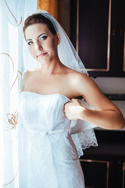 istock beautiful bride getting ready in white wedding dress with hairstyle 475230168