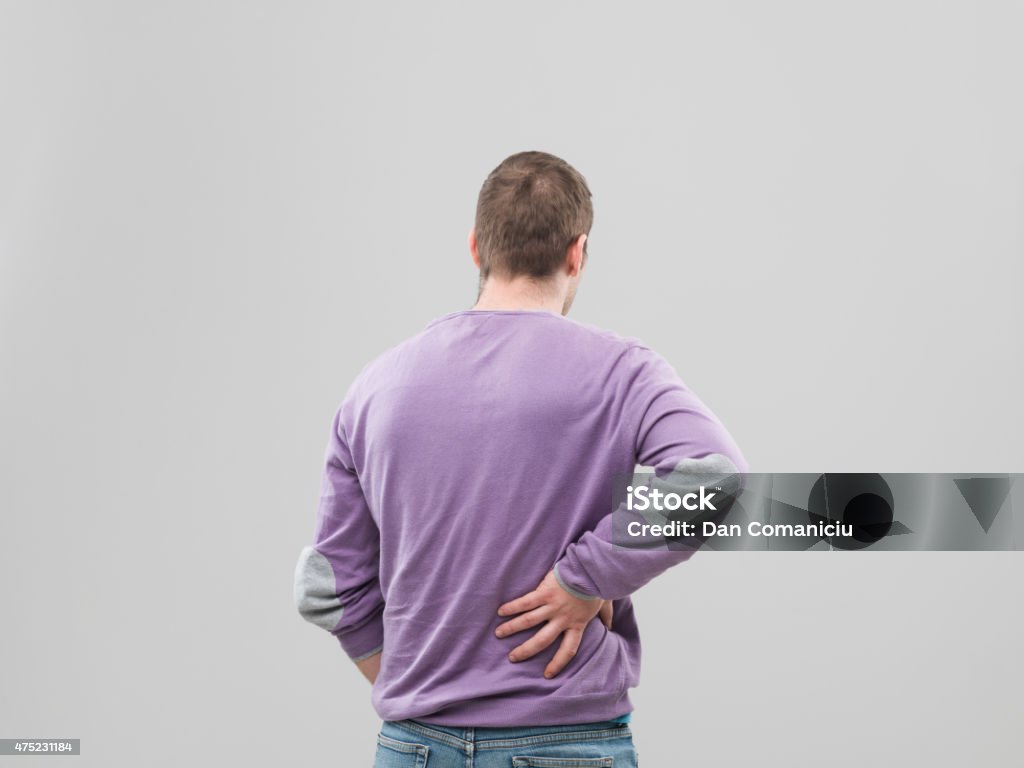 back pain rear view of man having back pain 2015 Stock Photo