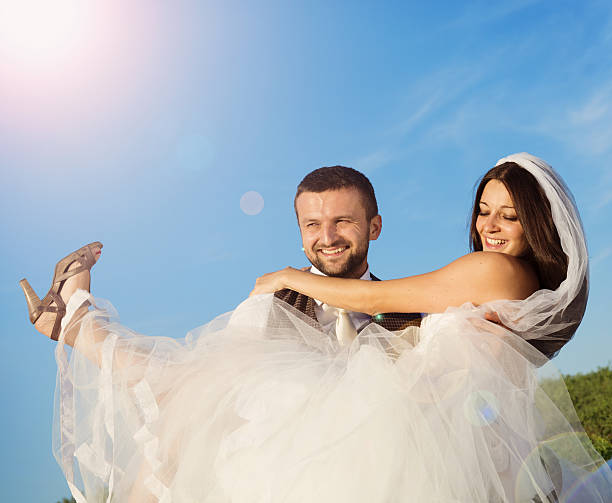 istock Newly married couple portrait with blue sky 475236595