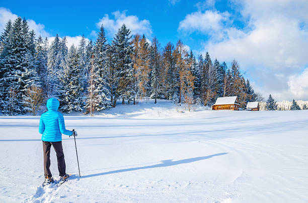 istock Woman in blue dawn jacket with mountain hut 475237068