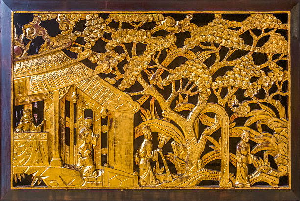 Georgetown, Penang, Malaysia - August 23, 2013: Carved golden wall ornament on an old Chinese temple in Georgetown city