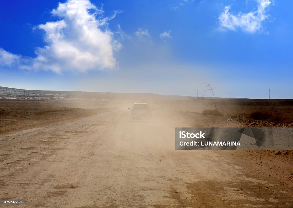 Dust road with car in  brown fog at Lanzarote Dust road with car in  brown fog at Lanzarote Ajaches 2015 Stock Photo