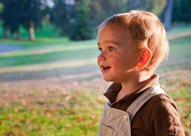istock Happy Baby boy is playing in the park during sunset. 475237623