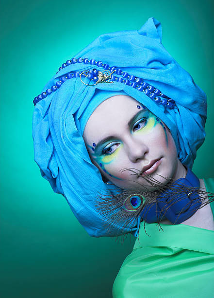 istock Young woman with peacock feathers 475237983