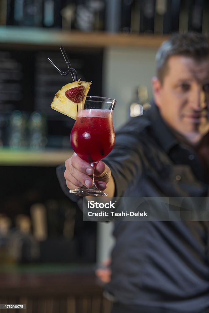Bartender with a cocktail Bar man holding a fresh cocktail. Alcohol - Drink Stock Photo