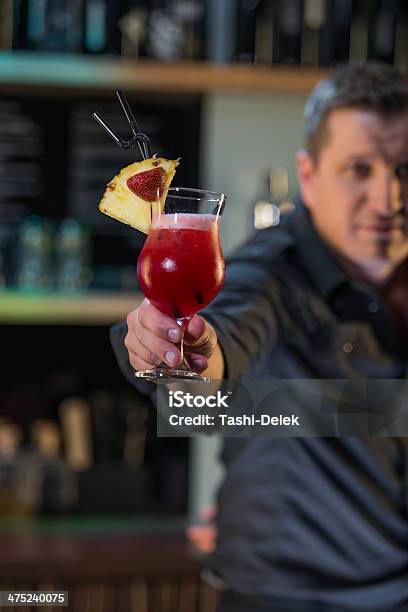 Bartender With A Cocktail Stock Photo - Download Image Now - Alcohol - Drink, Bartender, Blue
