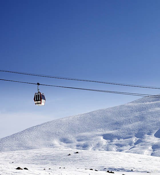 istock Gondola lift and ski slope at nice sun day 475242048