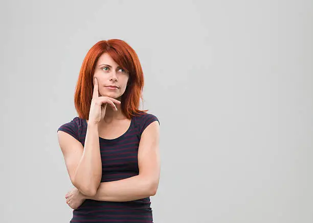 portrait of young caucasian woman with thinking gesture. copy space available