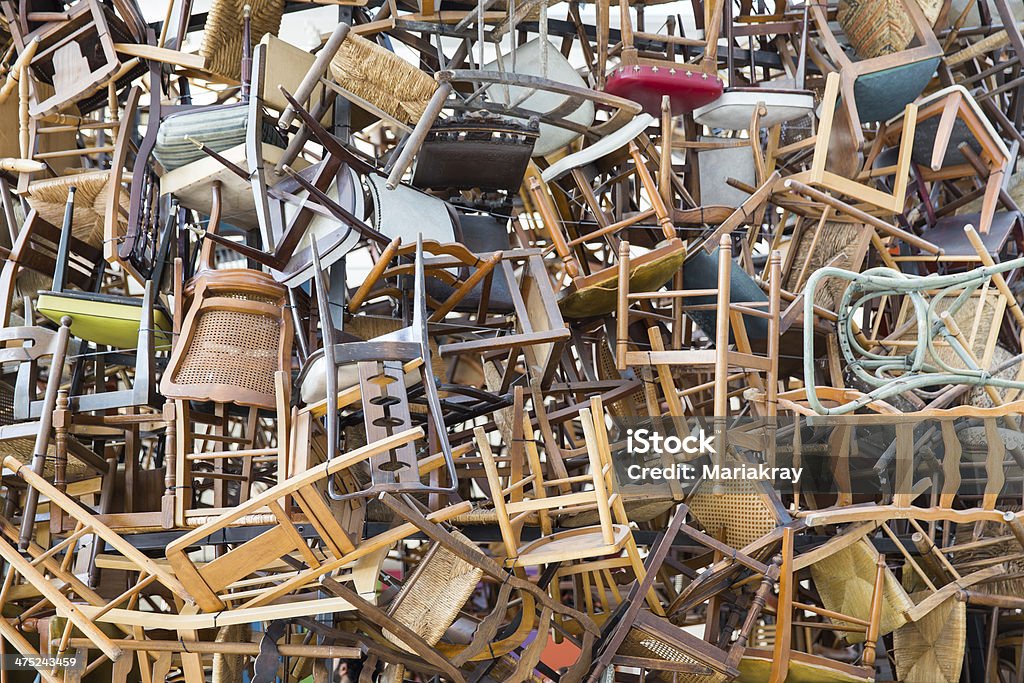 stack of chairs hundreds of vintage chairs stacked in a pile Office Chair Stock Photo