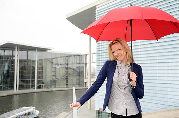 istock Berlin, happy female manager with umbrella 475243702
