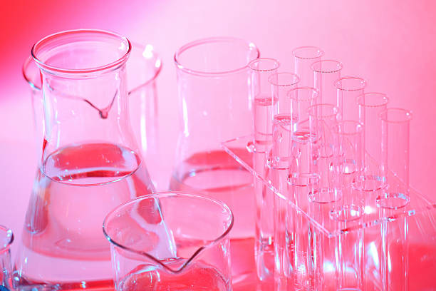 istock Science laboratory red, pink background, glass flask, beakers, test tubes 475244107