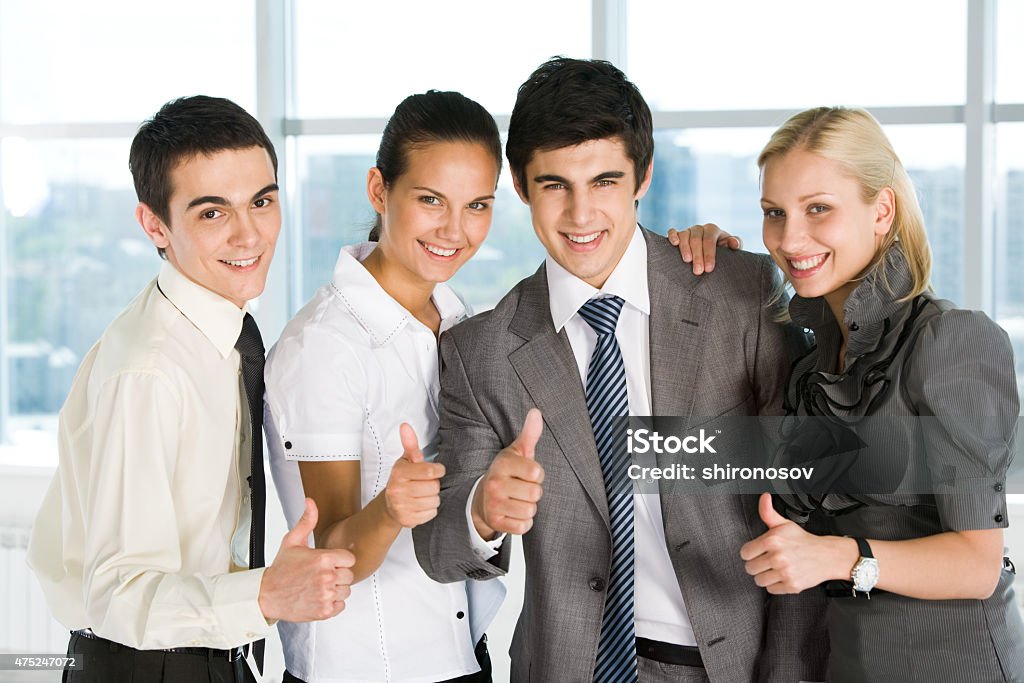 Success Portrait of happy business partners looking at camera with smiles and showing sign of okay  2015 Stock Photo