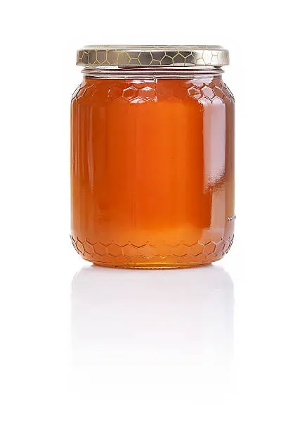 a honey jar isolated on a white background