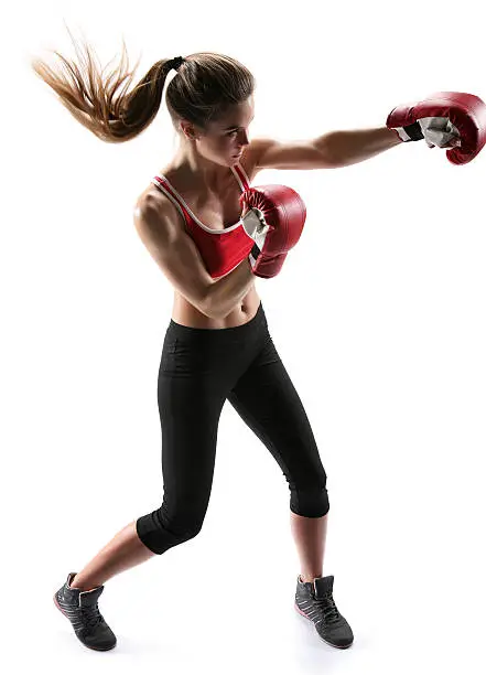 Female boxer punching wearing boxing gloves / photo set of sporty muscular female brunette girl wearing sports clothes over white background