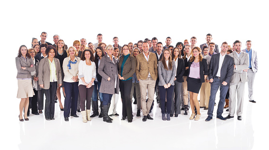 Large group of happy business people standing together and looking at the camera. Isolated on white.