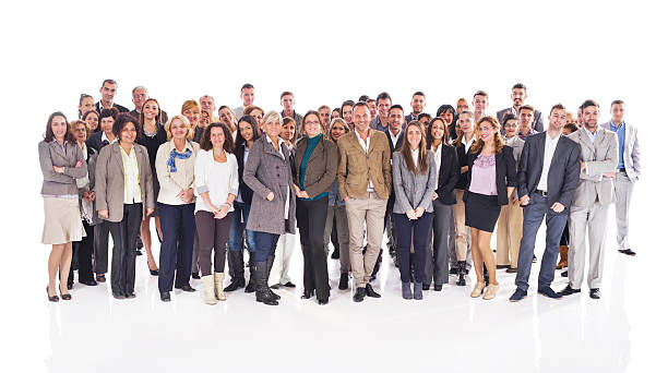 Crowd of happy business people isolated on white. Large group of happy business people standing together and looking at the camera. Isolated on white. large group of people facing camera stock pictures, royalty-free photos & images
