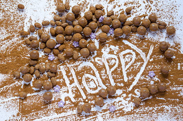 Chocolate balls on a table with the word Happy written in the chocolate