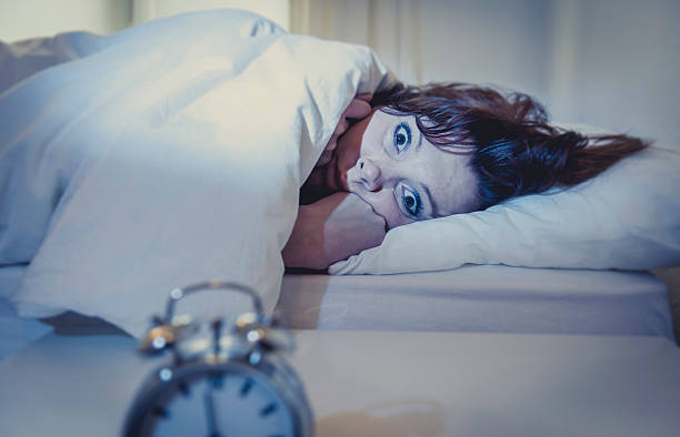 istock woman in bed with insomnia that can't sleep white background 475251701