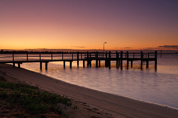 Shoalhaven river at dawn Beautiful dawn skies aglow in warm yellow and orange hues and their reflected colours in the Shoalhaven River shoalhaven photos stock pictures, royalty-free photos & images