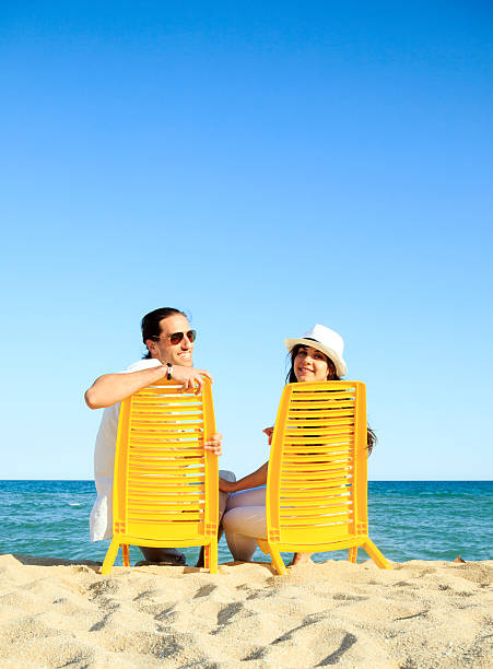istock Young couple sitting a  the seashore 475254002