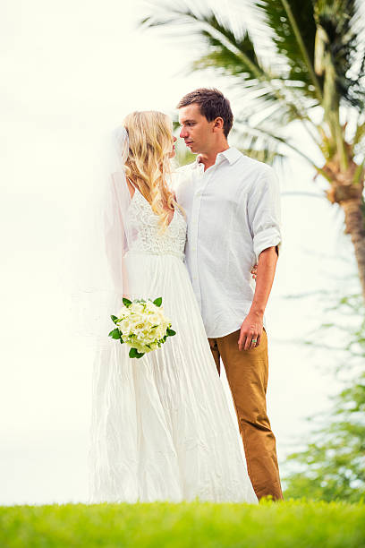 istock bride and groom at sunset on tropical beach 475255037
