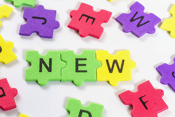 istock word NEW formed with colorful foam puzzle  on white background 475255391