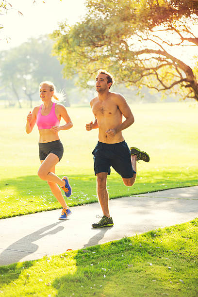 istock Couple running together in the park 475258735