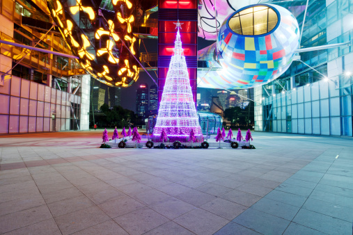Shanghai, China-December 23, 2013: This is a city square in the bund of Shanghai,Time is the night of Christmas,Christmas ornaments And decorations of the square,The lights and neon lighting,The background is in pudong, Shanghai,people waiting for the New Year blessings.