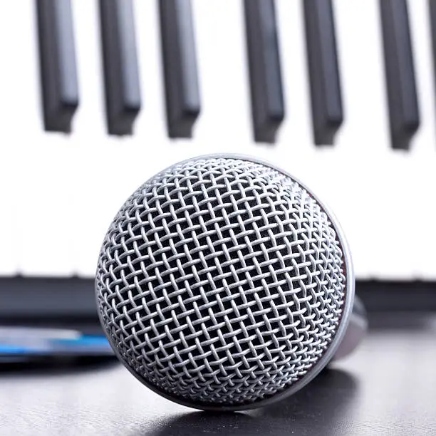 Photo of Microphone and piano keyboard