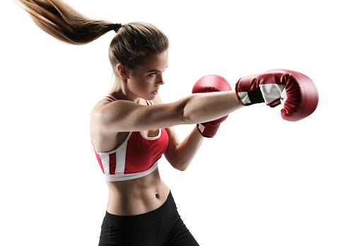 Boxer woman during boxing exercise making direct hit with red glove / photo set of sporty muscular female brunette girl wearing sports clothes over white background