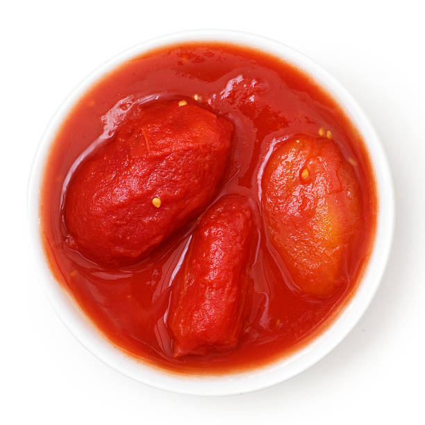 istock Whole canned tomatoes in white dish. Isolated above. 475264370