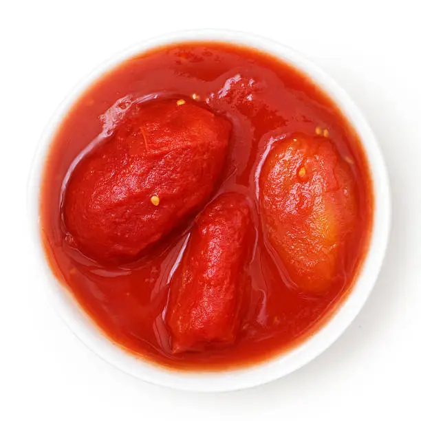 Whole canned tomatoes in white dish. Isolated above.