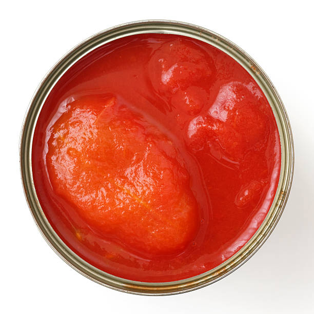 istock Whole open can of tomatoes isolated from above. 475264372