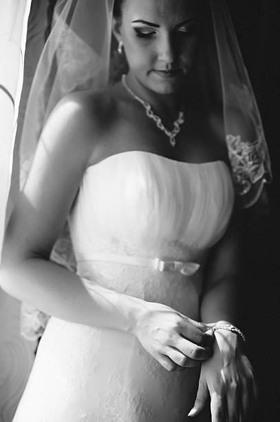 istock beautiful bride getting ready in white wedding dress with hairstyle 475268168