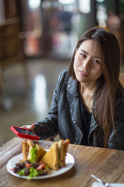 istock young woman using phone in coffee shop 475268810