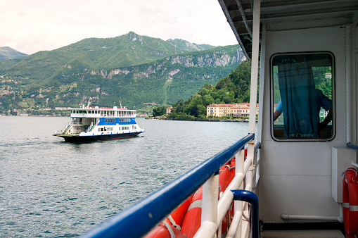 Bellagio, Italy - June 10, 2012: Ferry Boat seen from a second Ferry entering Bellagio port in Como lake, North Italy.  