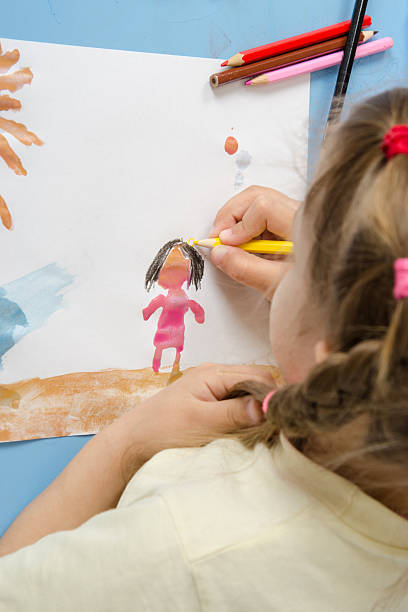 istock Girl draws a pencil on drawing painted colors 475273262