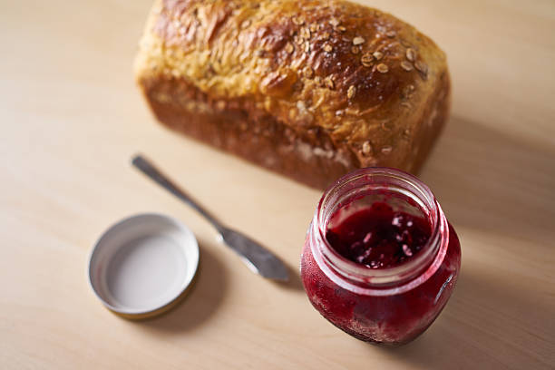 Freshly baked bread with strawberry jam stock photo