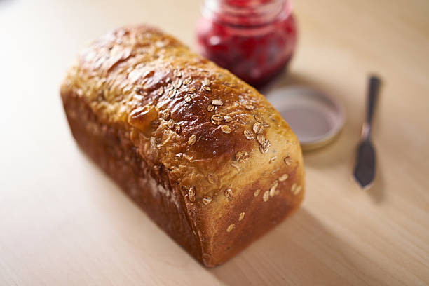 Close up of freshly baked bread with strawberry jam stock photo