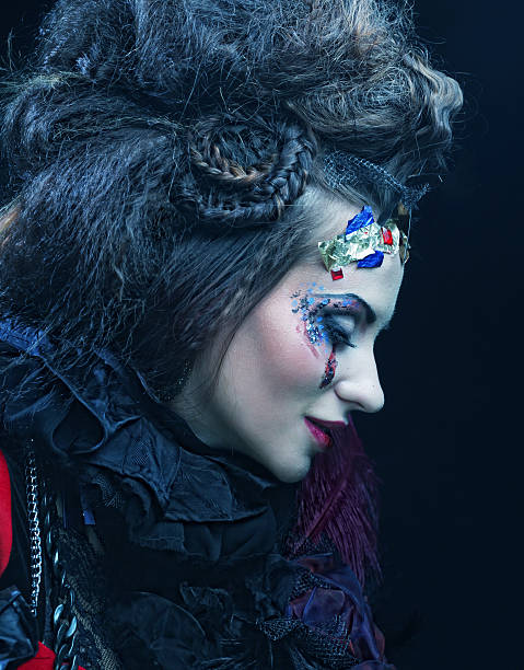 istock woman with artistic make-up in blue smoke 475276548