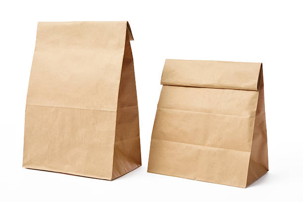 два пустых коричневый бумажный сумки, изолированные на белом фоне - bag white paper bag paper стоковые фото и изображения