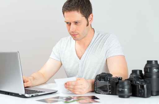 Photographer selecting photos on his computer.