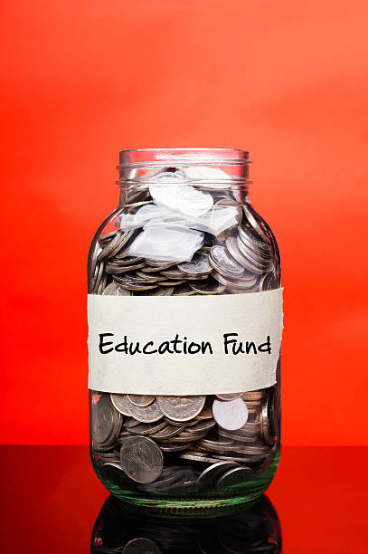 Education Fund - Financial Concept Education fund label on glass jar with coins a penny saved stock pictures, royalty-free photos & images