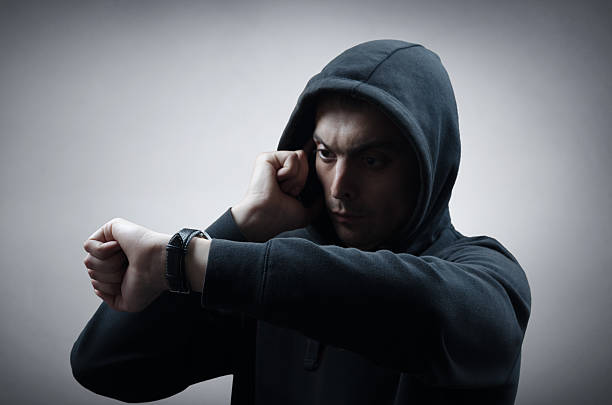 istock man with a hood on his head 475277592