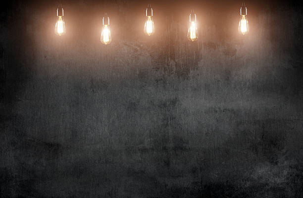istock wooden interior room with classic Edison light bulb 475281166