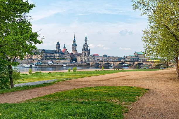 Dresden old town and river Elbe from the Elbwiesen shore. Hofkirche and Hausmannsturm